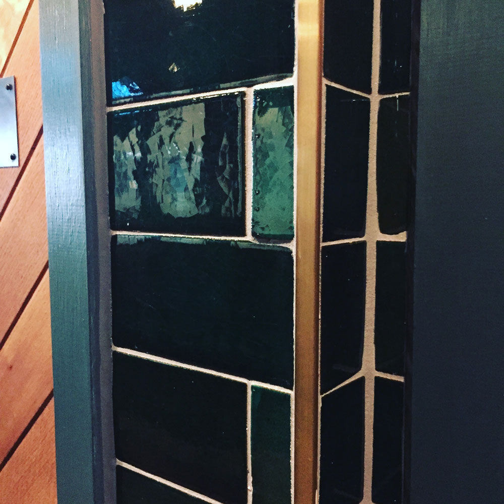 bronze tile trim with green tiles